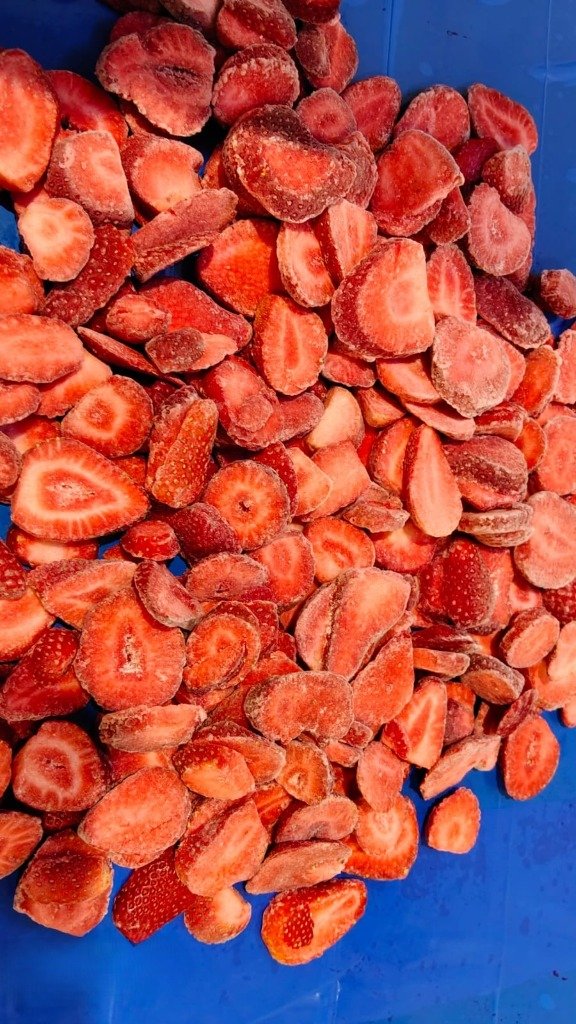 Close up showing exact thickness of IQF strawberry slices